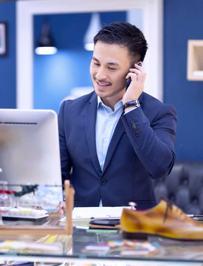 small business employee reviewing his business account with free mobile banking app